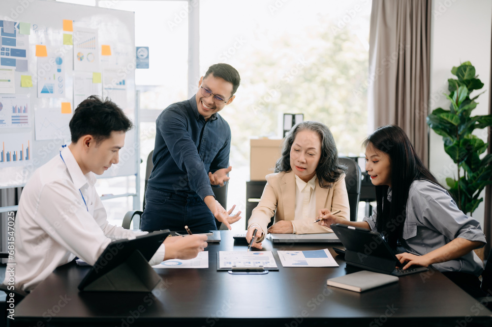 Happy businesspeople while collaborating on a new project in an office. Group of diverse businesspeople