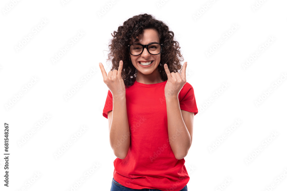 portrait of a young caucasian leader woman with black curly hair dressed in a red basic t-shirt actively gesturing with her hands portrait of a young caucasian leader woman with black curly hair dressed in a red basic t-shirt actively gesturing with her hands