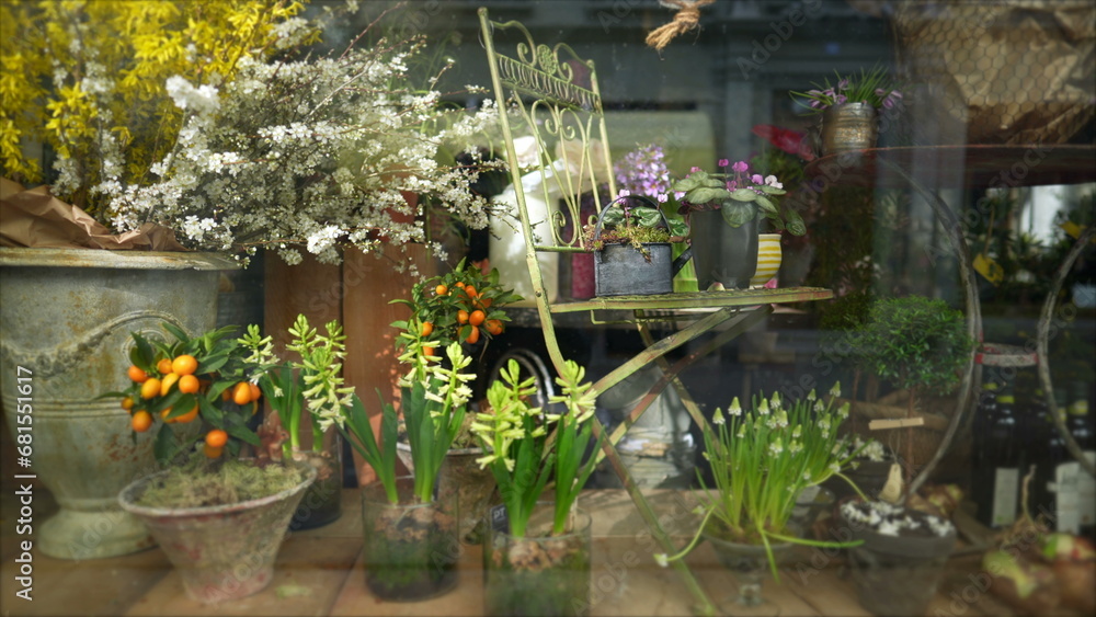 Flower shop on display behind glass window, quaint traditional beauty, small business