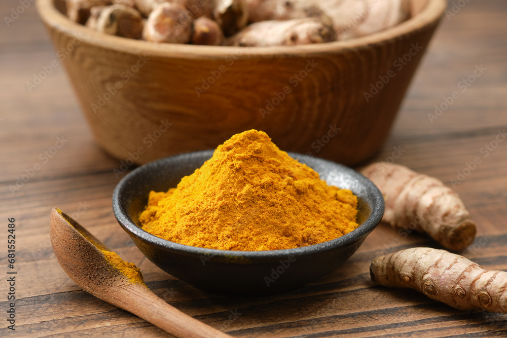 Turmeric spice. Curcuma powder seasoning and whole turmeric roots.