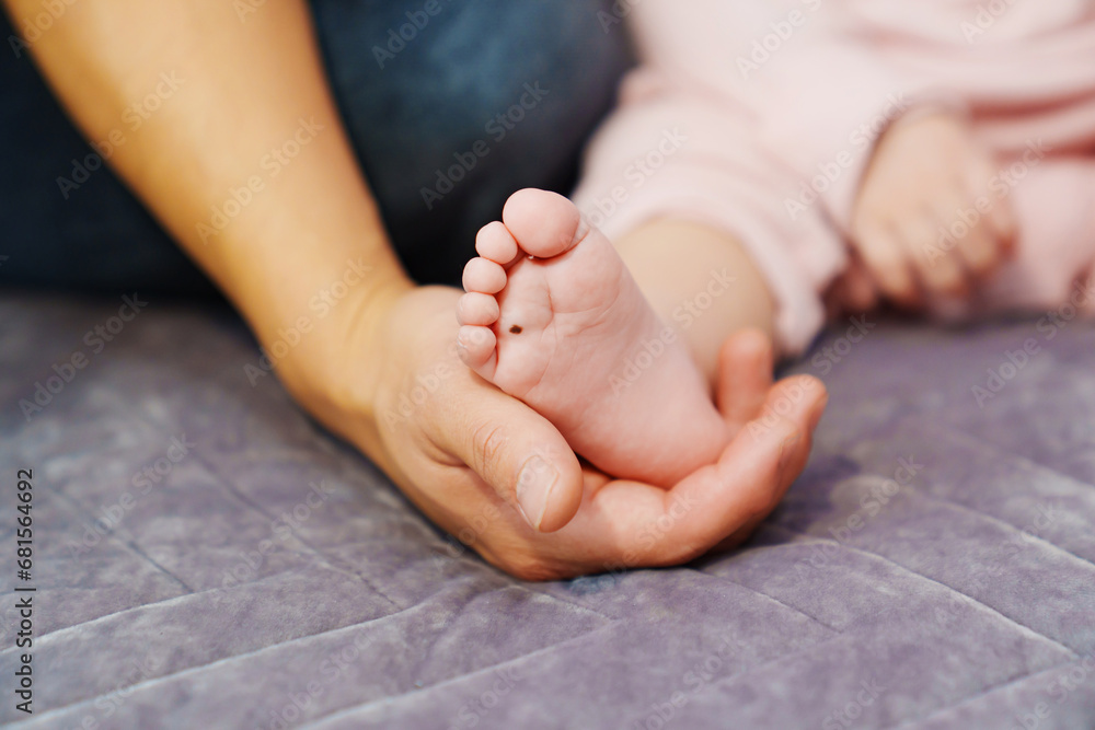 Small children's feet in their parents' hands. Small children's feet in their parents' hands.