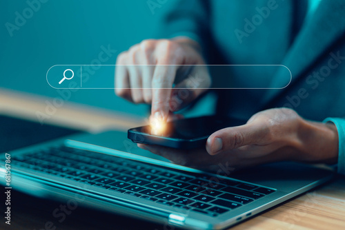businessman using a laptop and phone show search bar. concept of a website to find a job and career on the Internet, keyword search engines, tool digital online, web browser information optimization photo