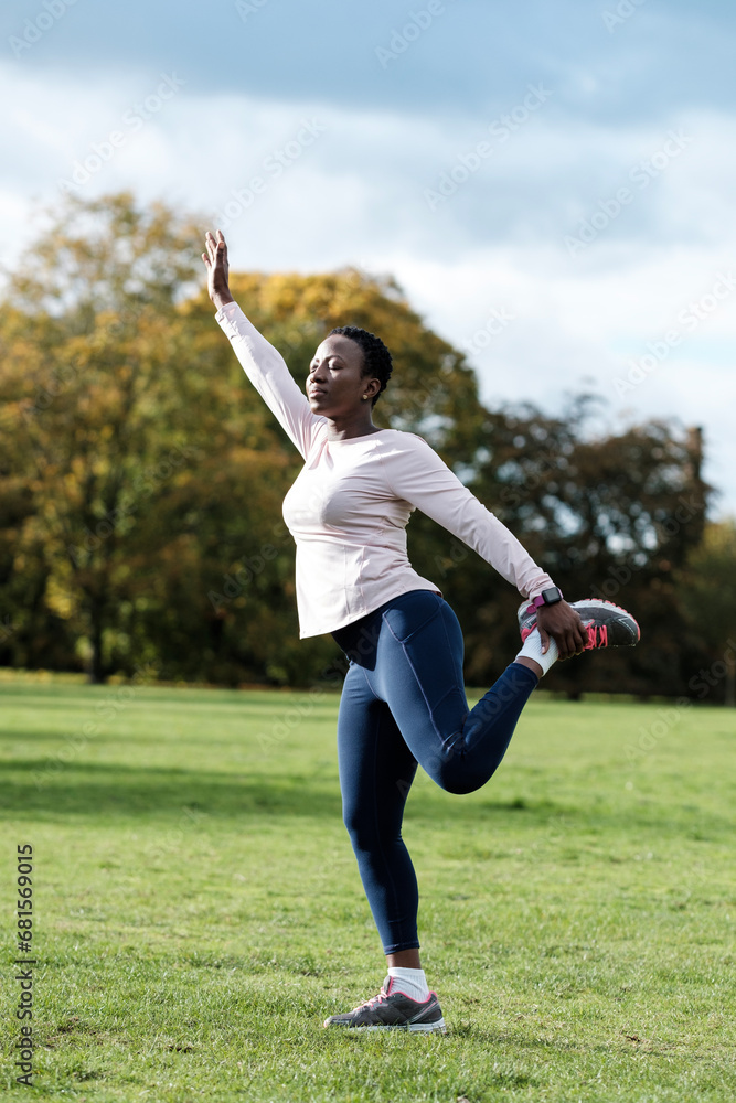 Short hair mature woman stretching in a park. Short hair mature woman stretching in a park.
