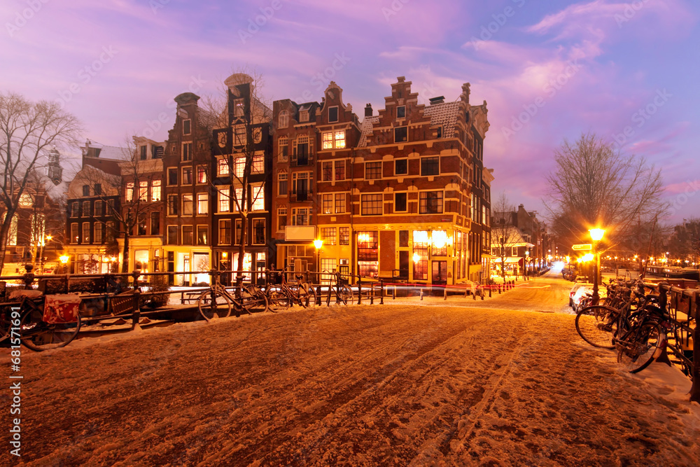 Snowy Amsterdam at sunset in the Netherlands