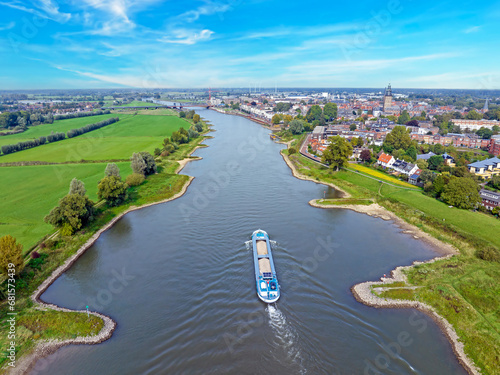Cargo ship cruising on the river IJssel near Zutphen in the Netherlands photo