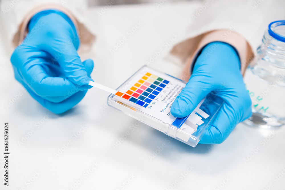 Close up scientist test checks a pH using indicator paper. Stock Photo ...