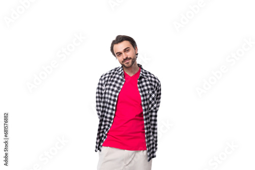 portrait of a young caucasian handsome guy with a beard and styled hair dressed in a plaid shirt