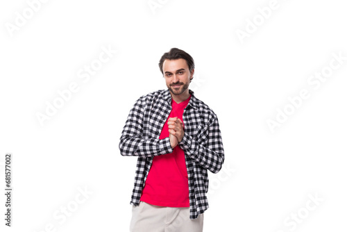 young handsome brunette man with a cool hairstyle and beard in a shirt on a white background with copy space