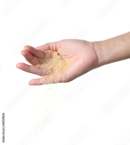 Hand holding brown sugar on white background