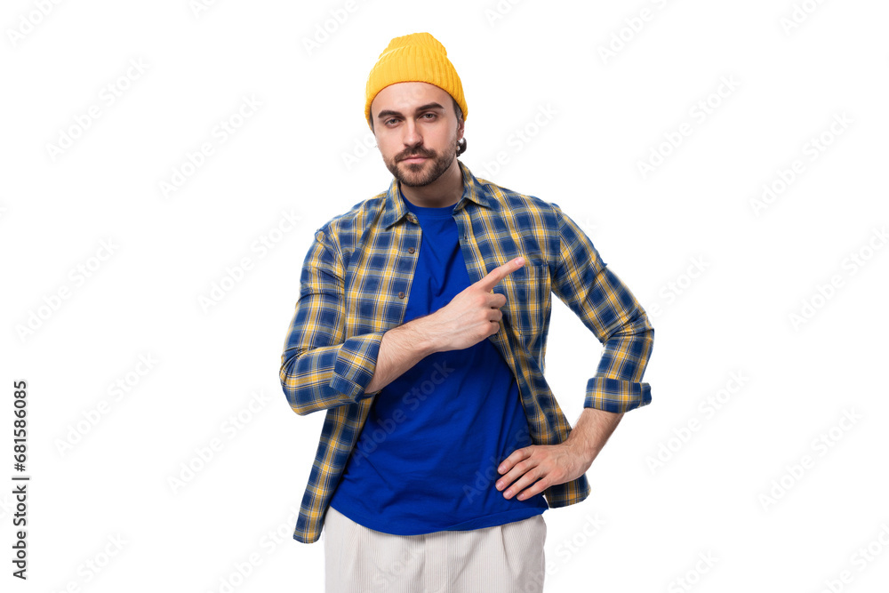 young stylish caucasian brunette handsome guy with a well-groomed beard and mustache in a plaid shirt young stylish caucasian brunette handsome guy with a well-groomed beard and mustache in a plaid shirt