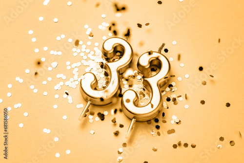 Canvas Print 33 years birthday celebration festive background made with golden candle in the form of number Thirty three lying on sparkles