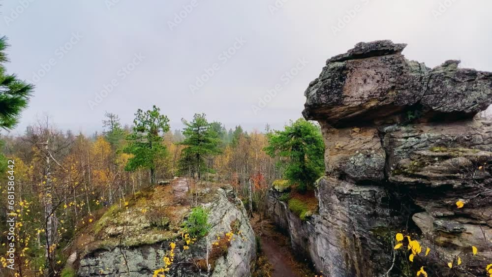 Stone City in autumn. Bright foliage and autumn landscape. The natural landscape is a rock formation in Central Russia, the Urals. A natural monument. Ancient rocky folding in the Ural Mountains. 4K Stone City in autumn. Bright foliage and autumn landscape. The natural landscape is a rock formation in Central Russia, the Urals. A natural monument. Ancient rocky folding in the Ural Mountains. 4K