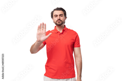 young handsome brunette man with a beard is dressed in a standard red t-shirt on a white background with copy space