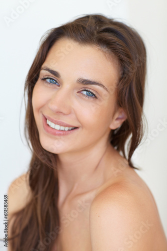 Portrait, beauty and aesthetic with a young woman in studio on a white background for natural skincare. Face, smile or cosmetics and a happy person looking confident with her antiaging skin routine