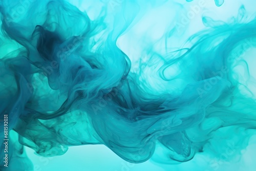 a mixture of blue and green ink in a liquid filled body of water with a light blue back drop in the top right corner of the image and the bottom half of the image.