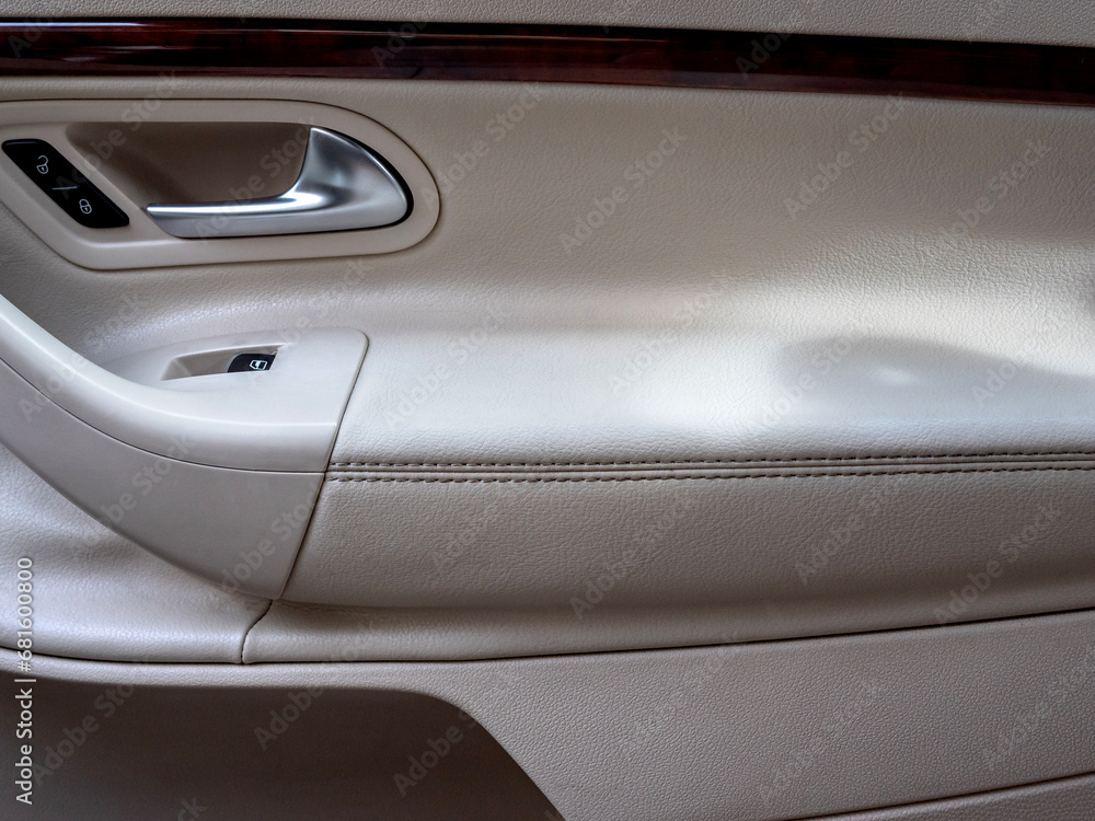Close up of the car interior. passenger side stitched leather door. Close up of the car interior. passenger side stitched leather door.