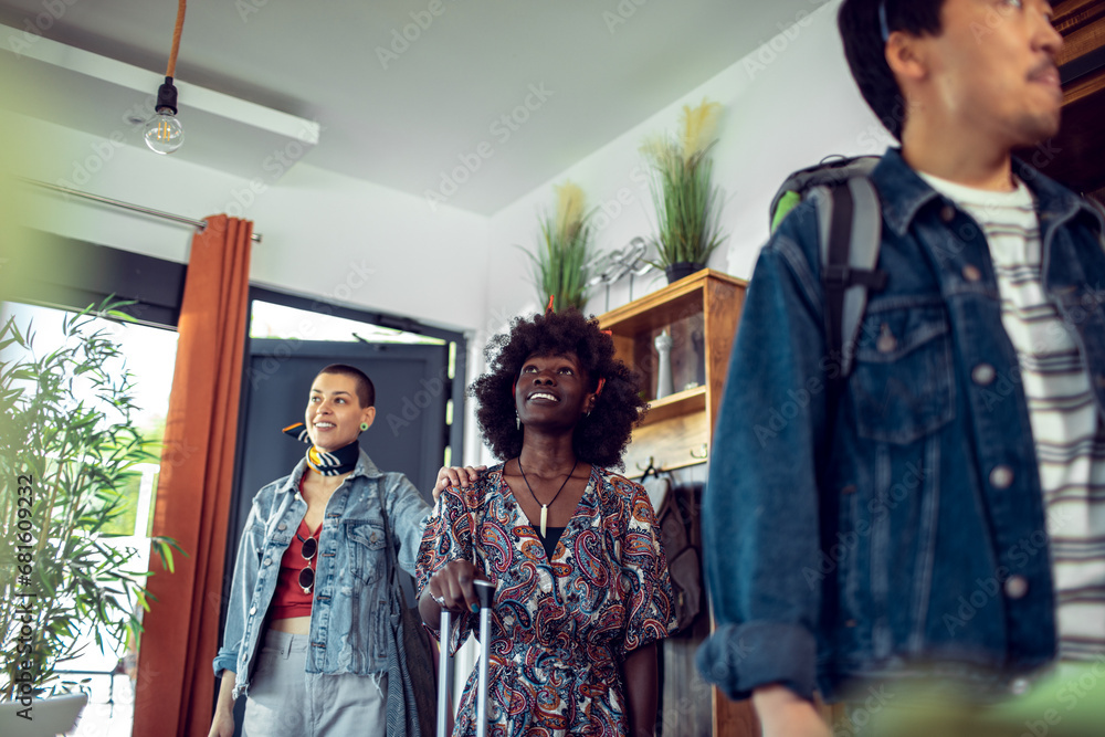 Diverse friends entering rented apartment Diverse friends entering rented apartment