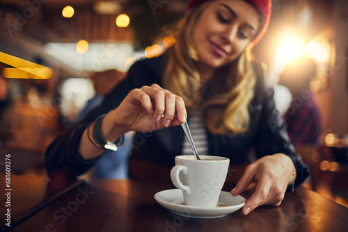 Stylish Woman Enjoying a Hot Cup of Coffee in a Cozy Cafe photo