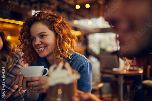 Stylish Woman Enjoying a Hot Cup of Coffee in a Cozy Cafe photo