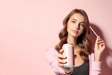 Woman holding pink soda can with paper straw on solid pastel background. ai generative