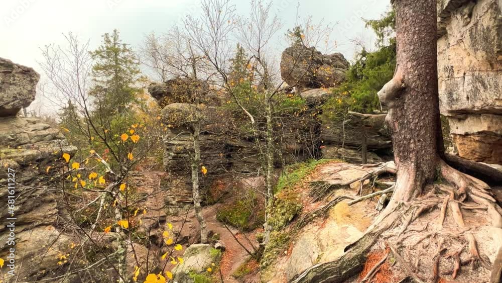 Stone City in autumn. Bright foliage and autumn landscape. The natural landscape is a rock formation in Central Russia, the Urals. A natural monument. Ancient rocky folding in the Ural Mountains. 4K Stone City in autumn. Bright foliage and autumn landscape. The natural landscape is a rock formation in Central Russia, the Urals. A natural monument. Ancient rocky folding in the Ural Mountains. 4K
