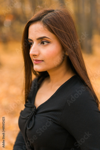 Close up portrait of pretty indian young woman enjoying warm autumn sunny day vacation outdoors. Generation z and gen z concept. Fall Season