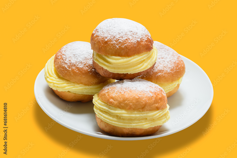 three bakery dreams on a white plate against a yellow background.