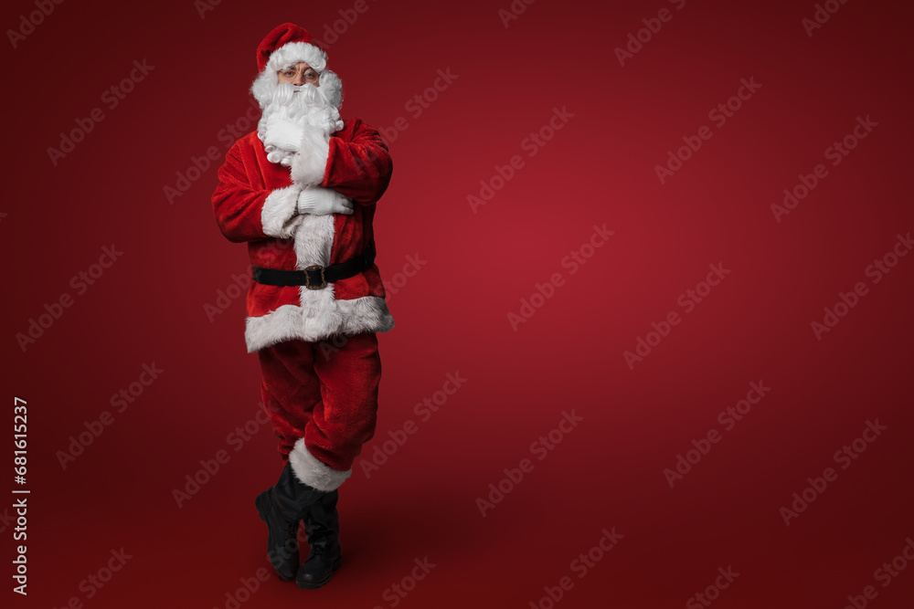 Santa Claus pondering, with a thoughtful pose on red background Santa Claus pondering, with a thoughtful pose on red background