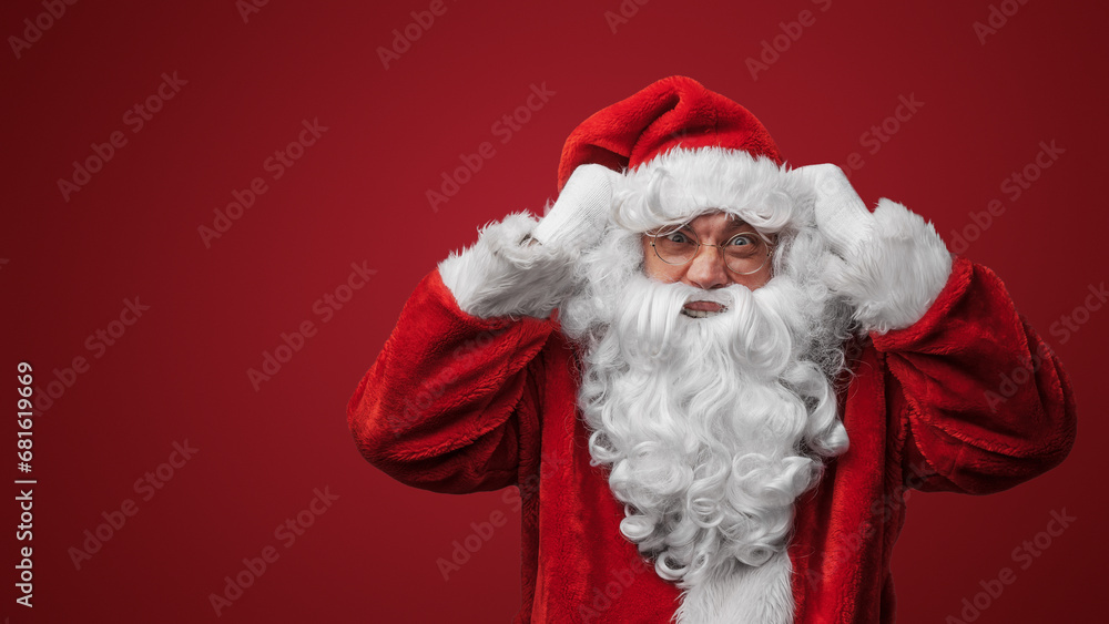 Shocked Santa Claus with a hand on head, surprised by holiday mischief Shocked Santa Claus with a hand on head, surprised by holiday mischief
