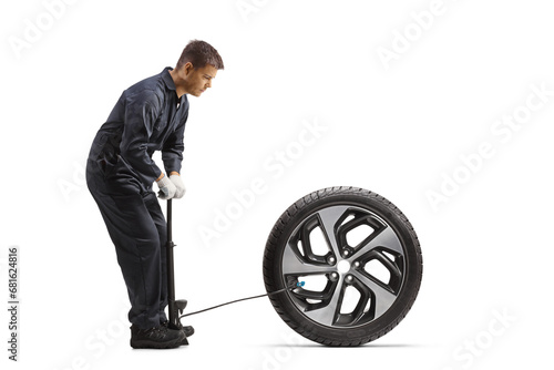 Car mechanic using a manual pump for a tire