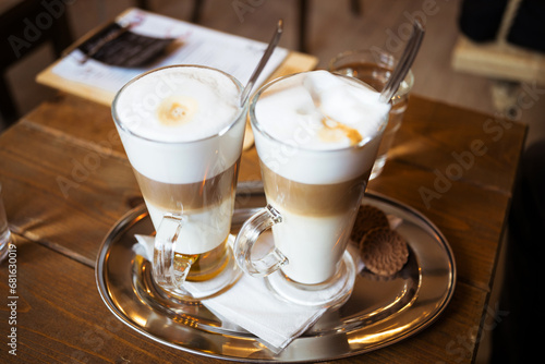 Morning coffee break - glass of latte macchiato and wiener melange coffee