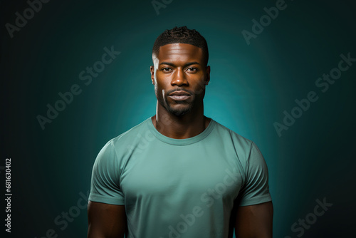 Portrait of a confident African American man in a green shirt against a dark studio background.