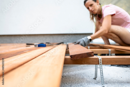 Woman making a new wooden patio in diy project