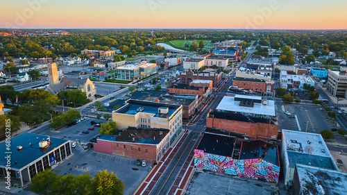 Colorful mural on building wall on S Walnut St with city aerial, Muncie, Indiana at dawn