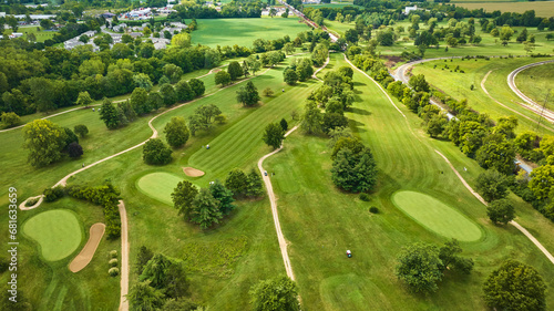 Golf course aerial above holes with lush green grass around holes with trees, Crestview Golf Club photo