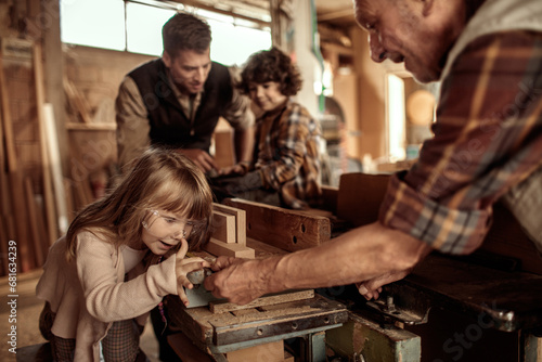 Father and His Children Enjoy Learning Carpentry Skills from Grandpa