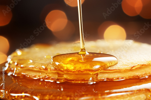 A drop of golden syrup glistens over a deliciously sweet pancake.