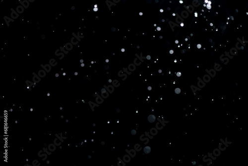 small drops of rain, snow on a black background. wind. Natural background