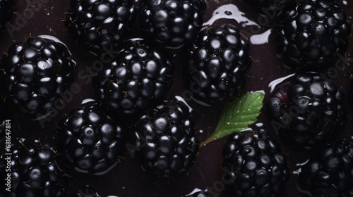 Cluster of glistening blackberries in close-up from an aerial perspective.