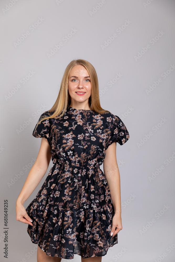 Portrait of a beautiful slender blonde woman in a dark summer dress Portrait of a beautiful slender blonde woman in a dark summer dress
