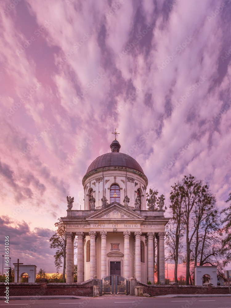 morning pink clouds above old cathedral in wide angle view