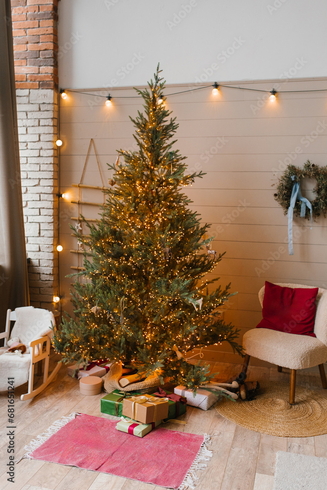 Obraz premium Modern Christmas tree with lots of lights and minimalist decoration in the Scandinavian living room