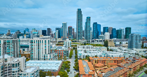Bayside Village residential housing aerial over Embarcadero with Oakland Bay Bridge in San Francisco city, CA