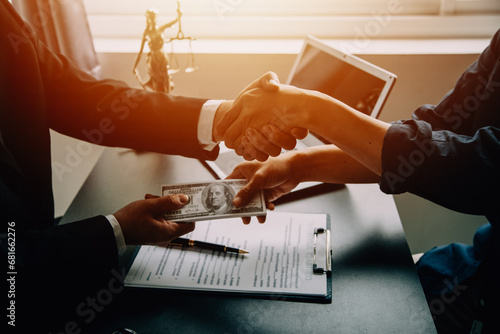 Business and lawyers discussing contract papers with brass scale on desk in office. Law, legal services, advice, justice and law concept picture with film grain effect