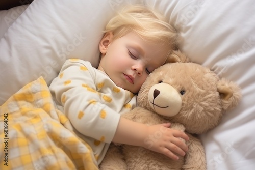 Little girl has sweet dreams in bed with favorite toy small teddy bear. Toddler girl with dark hair in shirt sleeps sweetly in company of best friend teddy bear seeing pleasant dreams.