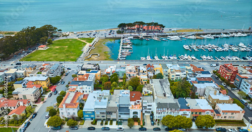 Photography Apartments and hotels beside docked boats at pier in San Francisco harbor aerial