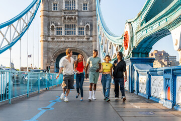 Multiracial group of happy young friends bonding in London city - Multiethnic teens students meeting and having fun in Tower Bridge area, UK - Concepts about youth lifestyle, travel and tourism