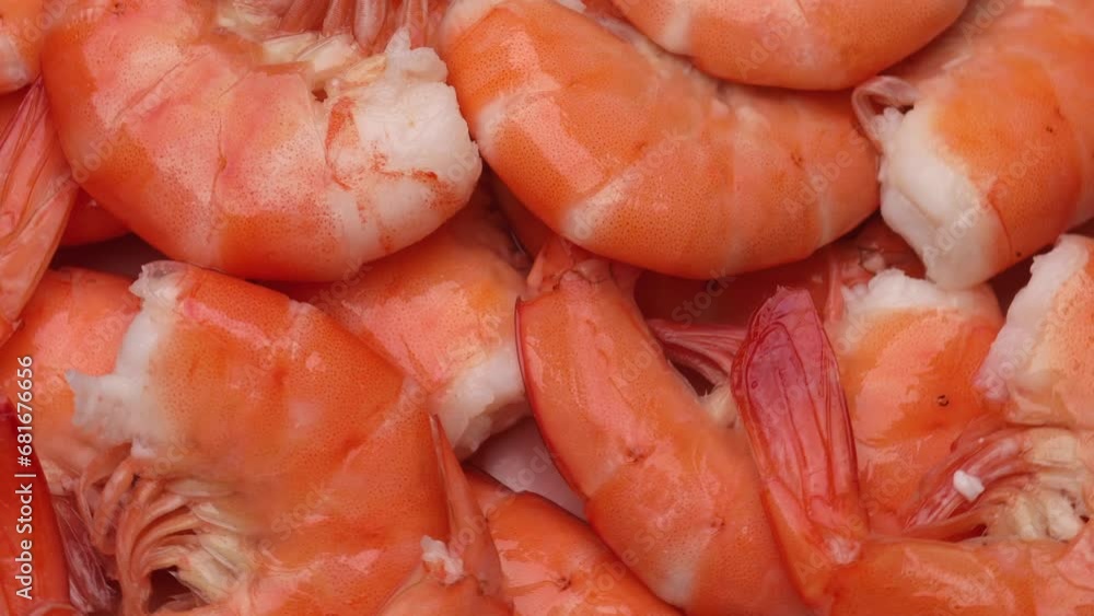 Pink shrimp in shell, rotation in circle. fish background, Turning. selective focus. cooked seafood Pink shrimp in shell, rotation in circle. fish background, Turning. selective focus. cooked seafood