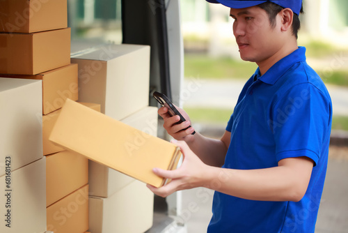 Courier is carefully inspecting the package for authenticity before delivering it to the customer, delivery driver collects all the boxes and prepares them to be delivered to the customer without fail photo
