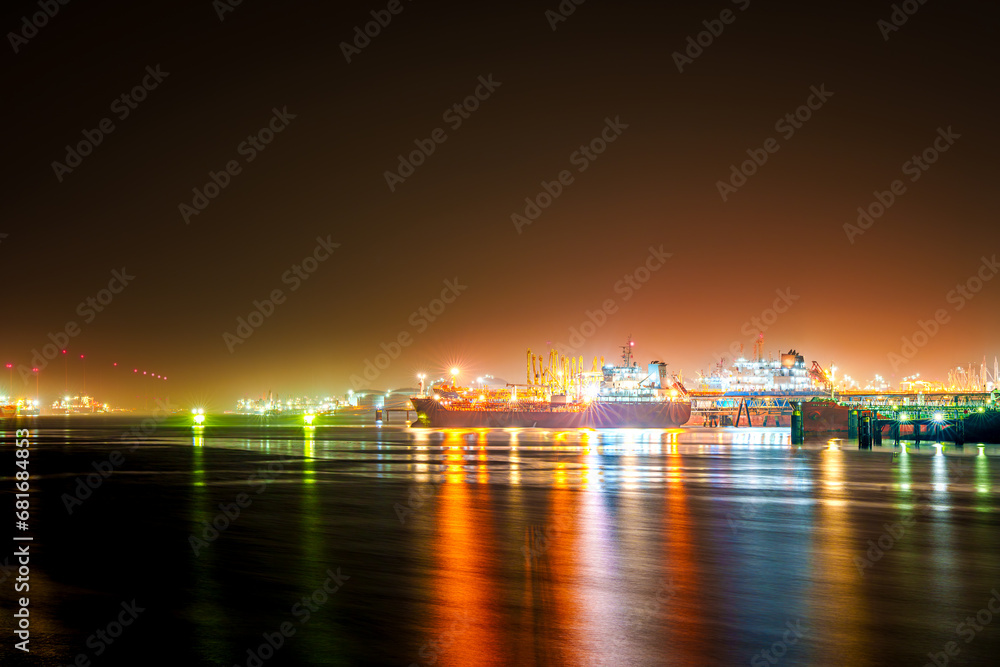 A captivating and surreal night shot of the Rotterdam port, shrouded in mystical mist, creating an enchanting and scenic atmosphere that evokes a sense of wonder and mystery.
